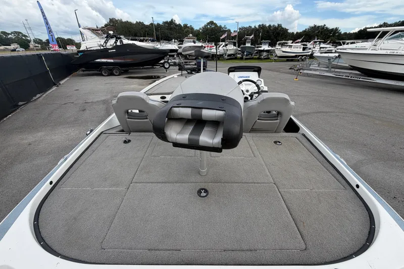 Slide: The Image of 2024 Nitro Z20 boat with spacious deck, parked among other boats at a marina. - 14