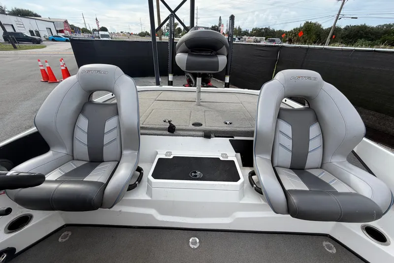 Slide: The Image of 2024 Nitro Z20 boat interior with two gray seats and a central storage compartment. - 58
