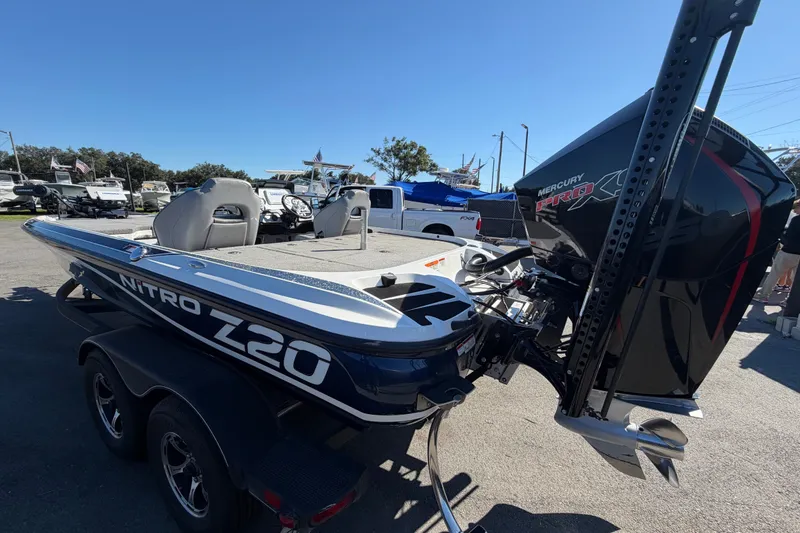 Slide: The Image of 2024 Nitro Z20 boat with Mercury Pro XS engine, parked outdoors on a sunny day. - 8