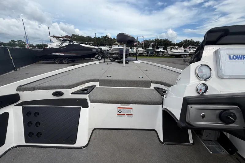 Slide: The Image of 2024 Nitro Z20 boat interior with seating and control panel, parked among other boats. - 30