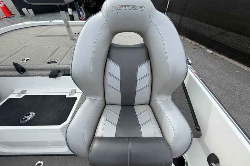 Slide: The Image of 2024 Nitro Z20 boat seat with gray and white upholstery, featuring sleek design and stitching. - 59