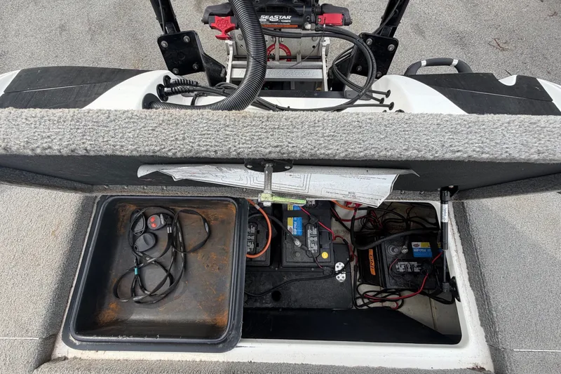 Slide: The Image of 2024 Nitro Z20 boat battery compartment with wiring and equipment. - 74
