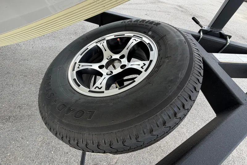Slide: The Image of Trailer tire on a Nitro Z20 boat trailer, 2024 model, featuring Load Star branding. - 86