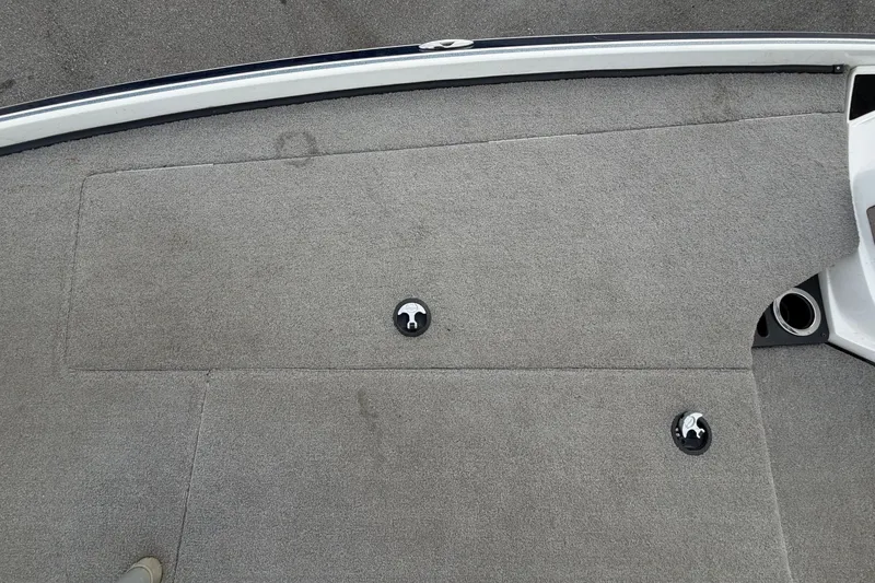 Slide: The Image of 2024 Nitro Z20 boat deck with gray carpet and metal trim. - 38