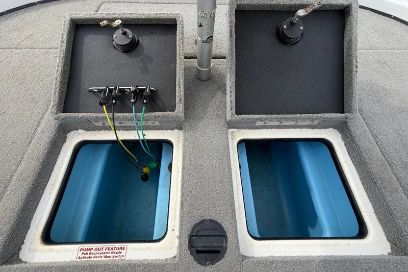 Slide: The Image of 2024 Nitro Z20 boat storage compartments with wiring and blue interior. - 67