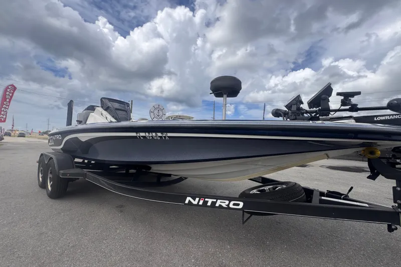 The Image of 2024 Nitro Z20 boat on trailer under cloudy sky, showcasing sleek design. - 0