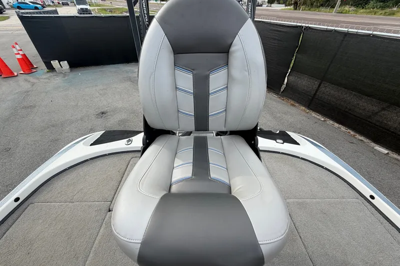 Slide: The Image of 2024 Nitro Z20 boat seat with gray and white upholstery, outdoor setting. - 65