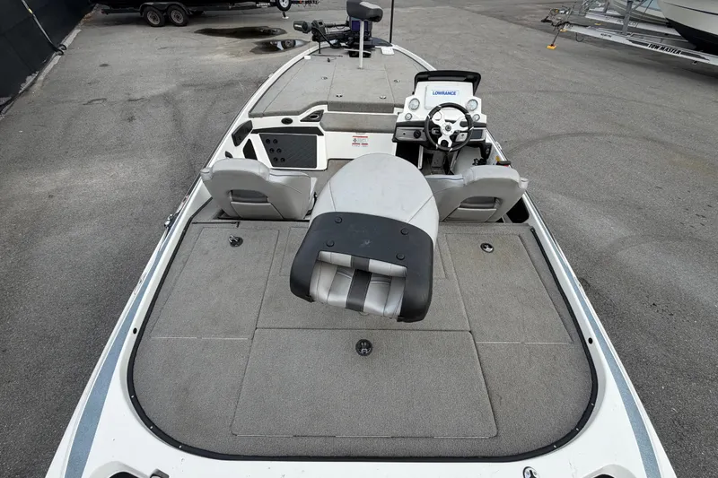 Slide: The Image of 2024 Nitro Z20 boat interior with steering console and seating on a concrete surface. - 13