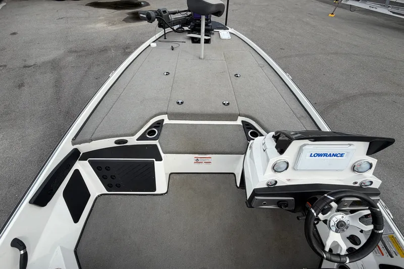 Slide: The Image of 2024 Nitro Z20 boat interior with Lowrance system and steering wheel, showcasing spacious deck. - 29