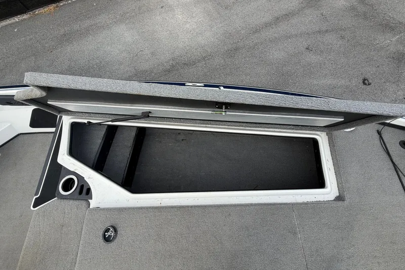 Slide: The Image of 2024 Nitro Z20 boat interior with storage compartment and gray flooring. - 37