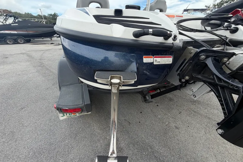 Slide: The Image of Rear view of a 2024 Nitro Z20 boat on a trailer in a parking lot. - 82