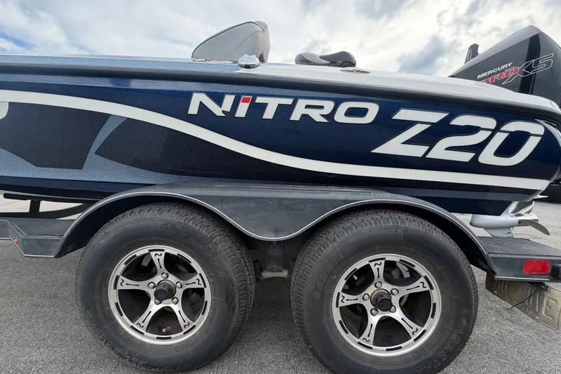 Slide: The Image of 2024 Nitro Z20 boat on trailer with dual wheels, showcasing sleek design. - 88