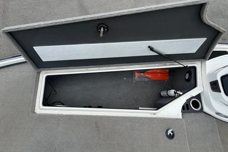 Slide: The Image of 2024 Nitro Z20 boat storage compartment with safety equipment and fire extinguisher. - 39