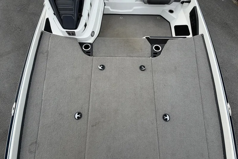 Slide: The Image of 2024 Nitro Z20 boat deck with gray carpeting and seating area. - 53