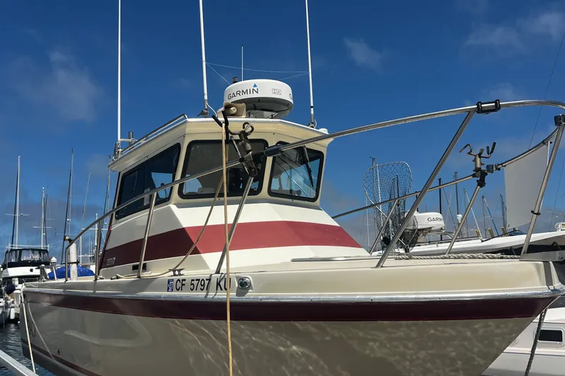 Slide: The Image of Skipjack Fisherman 1991 boat docked, featuring Garmin radar and fishing equipment. - 16