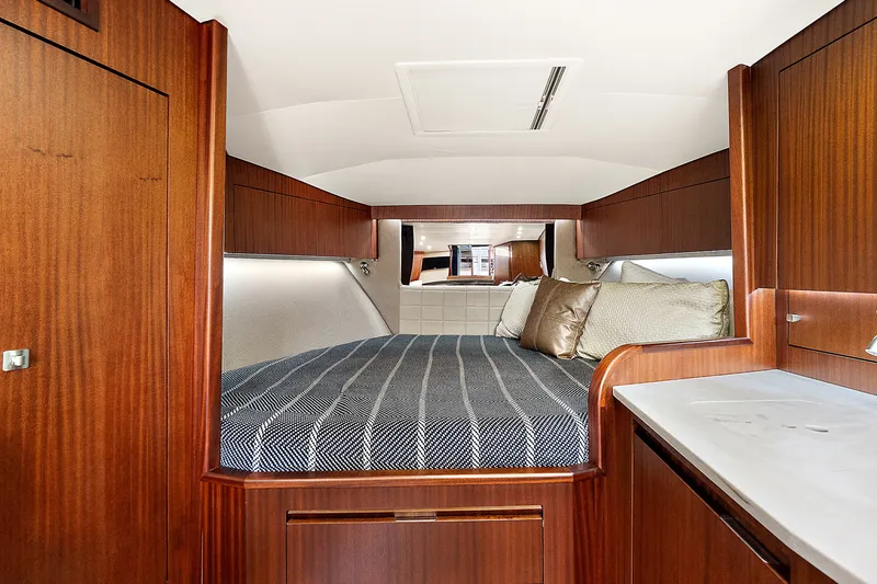 Slide: The Image of Luxurious cabin interior of 2021 Jupiter 41 SB yacht with cozy bedding and wood finish. - 20