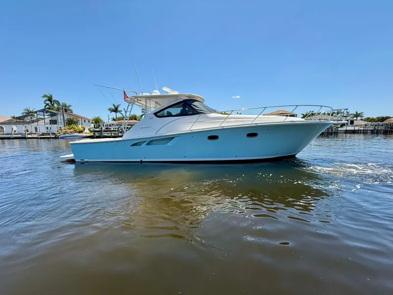 Slide: The Image of 2018 Tiara Yachts 4300 Open cruising on calm waters under a clear blue sky. - 1