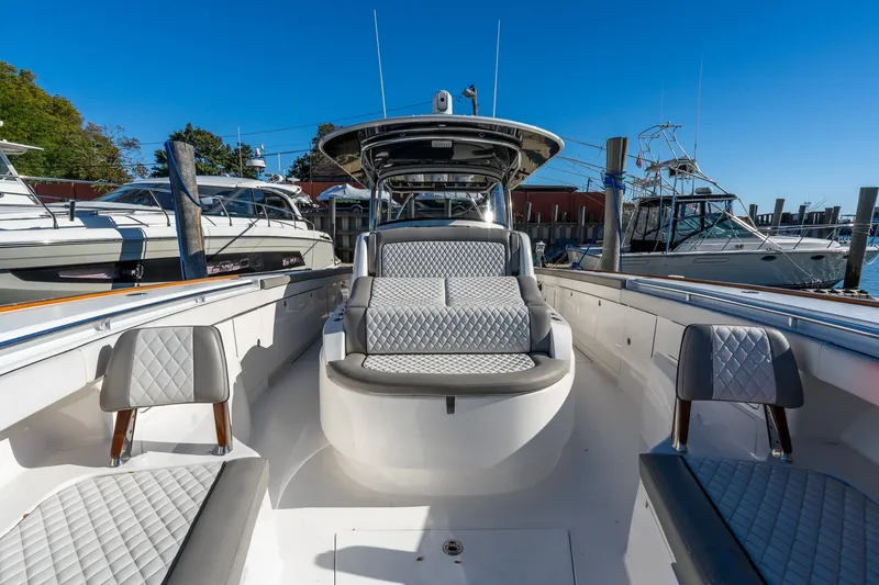 Slide: The Image of 2022 Valhalla V-46 boat interior with luxurious seating at a marina. - 44