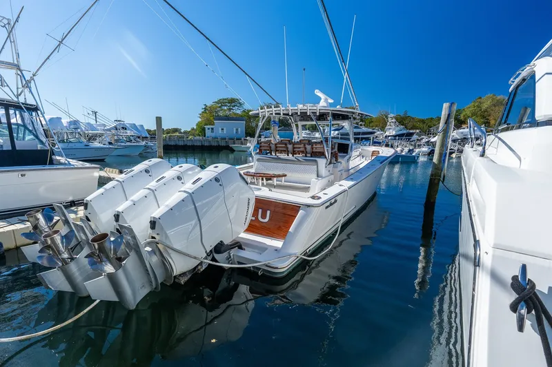 Slide: The Image of 2022 Valhalla V-46 boat docked with powerful outboard engines, clear blue sky. - 1