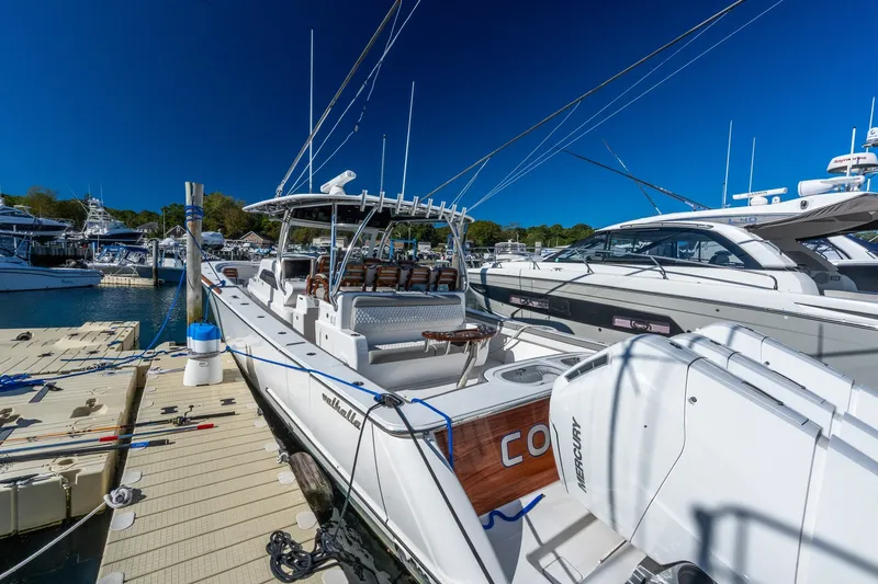 Slide: The Image of 2022 Valhalla V-46 boat docked at marina, featuring sleek design and powerful Mercury engines. - 6