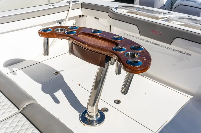 Slide: The Image of Fishing rod holder on 2022 Valhalla V-46 boat deck, featuring polished wood and metal design. - 9