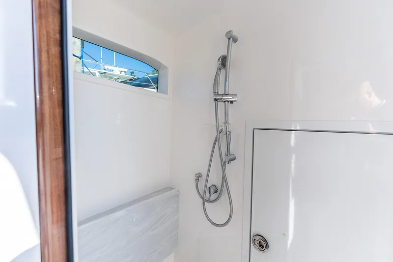 Slide: The Image of Shower area in 2022 Valhalla V-46 boat, featuring sleek chrome fixtures. - 42