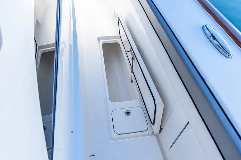 Slide: The Image of 2022 Valhalla V-46 boat deck with storage compartment, sleek design, and stainless steel details. - 15