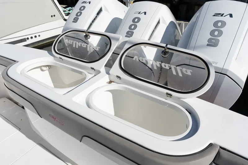 Slide: The Image of 2022 Valhalla V-46 boat with open storage compartments and powerful outboard engines. - 4