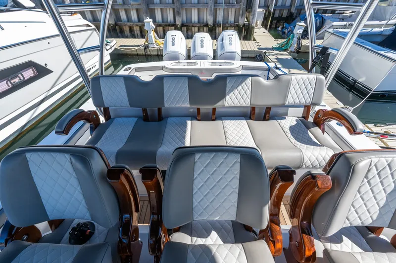 Slide: The Image of Luxury seating on 2022 Valhalla V-46 boat, featuring quilted upholstery and wooden accents. - 20