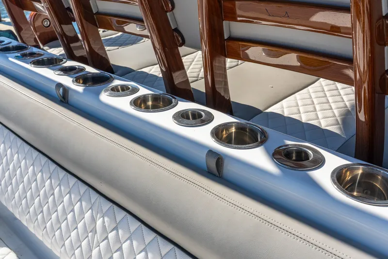 Slide: The Image of Luxurious seating with cup holders on 2022 Valhalla V-46 boat, featuring quilted upholstery. - 19