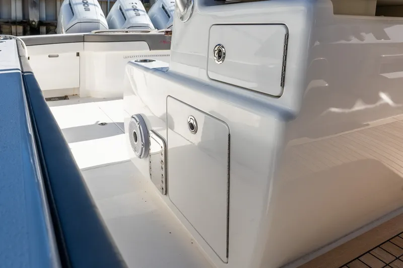 Slide: The Image of 2022 Valhalla V-46 boat interior with storage compartments and speaker system. - 22