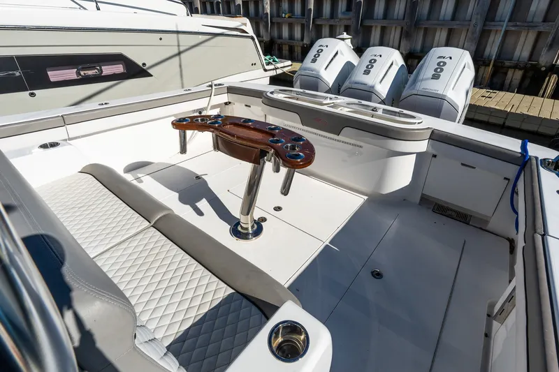Slide: The Image of 2022 Valhalla V-46 boat interior with seating and triple outboard engines. - 8