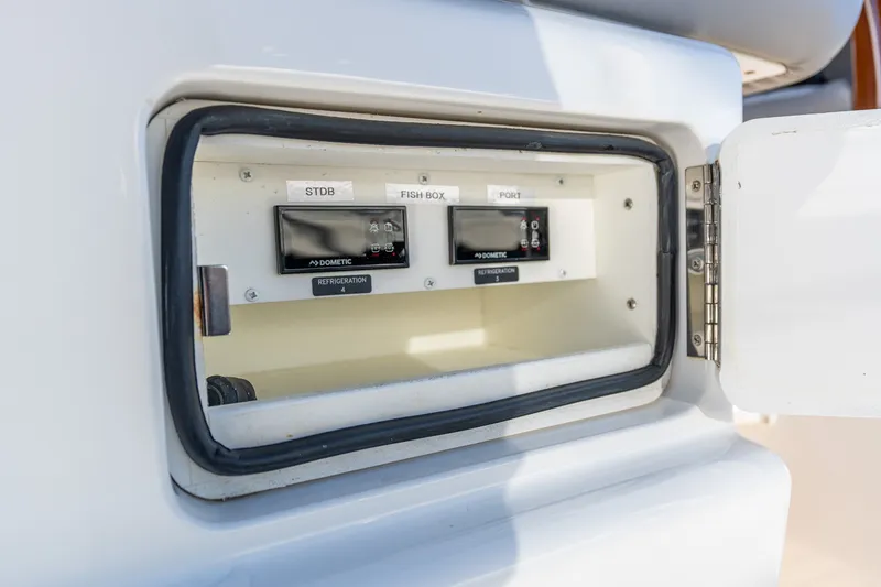 Slide: The Image of Control panel on 2022 Valhalla V-46 boat, featuring refrigeration settings and open compartment. - 60