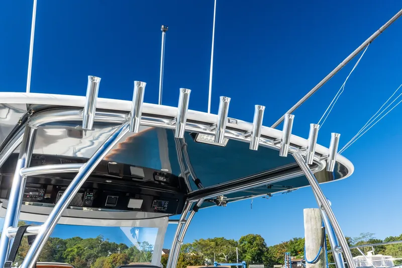 Slide: The Image of Valhalla V-46 boat's sleek metal framework and rod holders against a clear blue sky. - 16