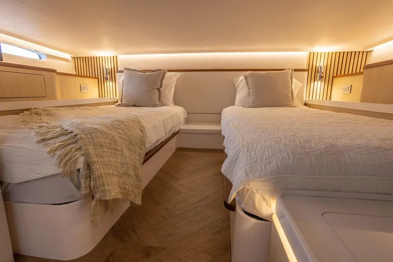 Slide: The Image of Manufacturer Provided Image: Luxurious twin cabin interior of 2026 Regal 43 SAV yacht with elegant bedding. - 15