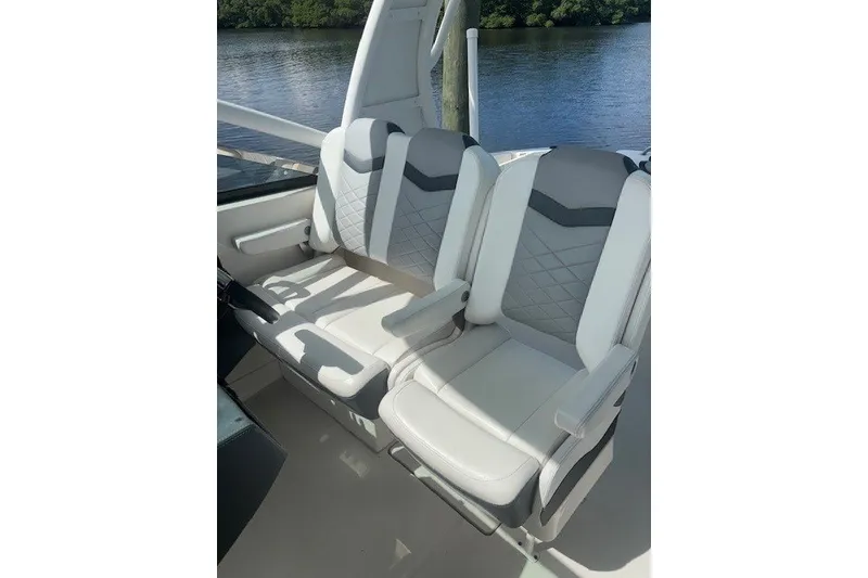 Slide: The Image of 2021 Chaparral 280 OSX boat seats with elegant design by the water. - 25