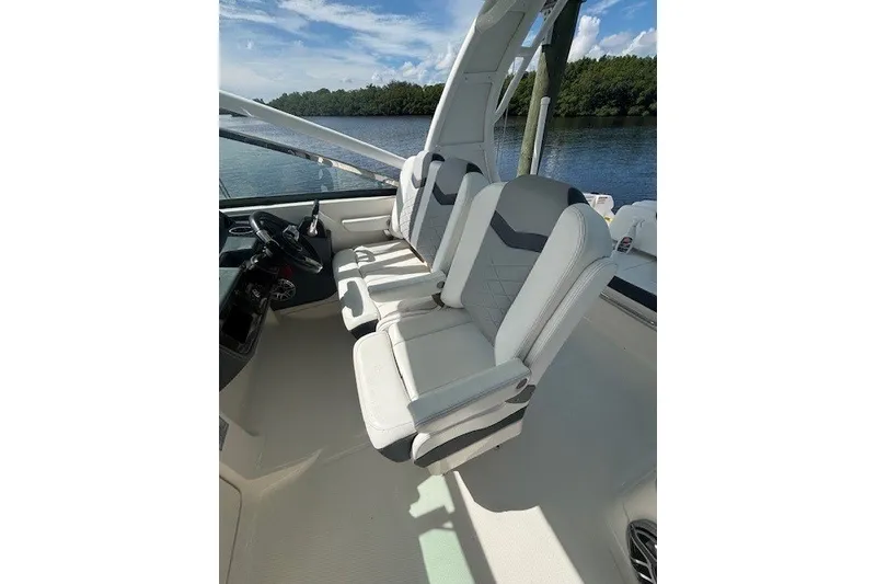 Slide: The Image of 2021 Chaparral 280 OSX boat interior with sleek seating and scenic water view. - 26