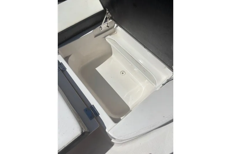 Slide: The Image of Open storage compartment on 2021 Chaparral 280 OSX boat, showcasing interior space. - 16