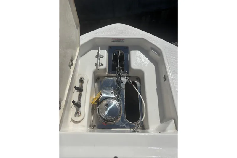 Slide: The Image of 2021 Chaparral 280 OSX boat anchor compartment with stainless steel fittings. - 13