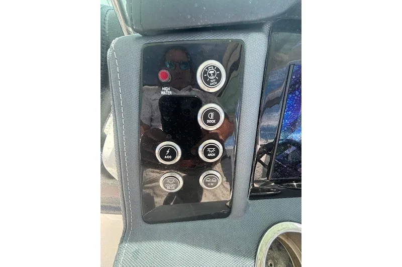 Slide: The Image of Control panel of 2021 Chaparral 280 OSX boat with various function buttons. - 33
