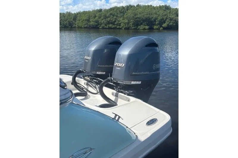 Slide: The Image of 2021 Chaparral 280 OSX boat with twin Yamaha 200 outboard engines on a calm lake. - 44