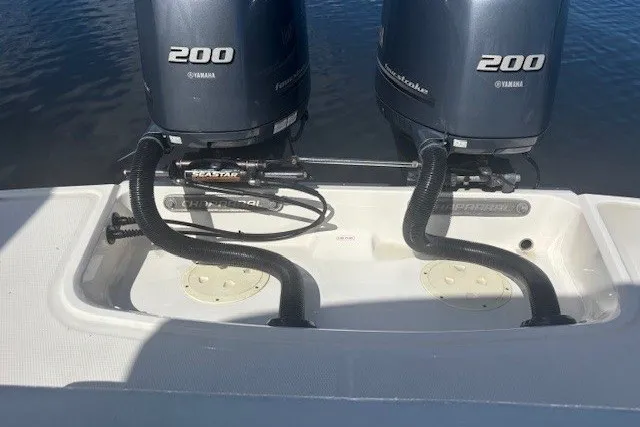 Slide: The Image of Twin Yamaha 200 engines on a 2021 Chaparral 280 OSX boat, docked on water. - 48