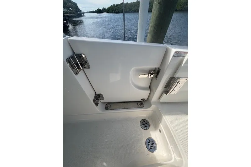 Slide: The Image of 2021 Chaparral 280 OSX boat deck with open hatch and water view. - 36