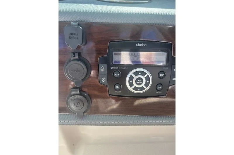 Slide: The Image of 2021 Chaparral 280 OSX dashboard with Clarion audio system and input ports. - 22