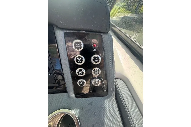 Slide: The Image of Control panel of a 2021 Chaparral 280 OSX boat with various function buttons. - 34