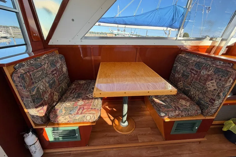 Slide: The Image of 1973 Chris-Craft 31 Sedan Cruiser interior with wood table and patterned seating. - 29