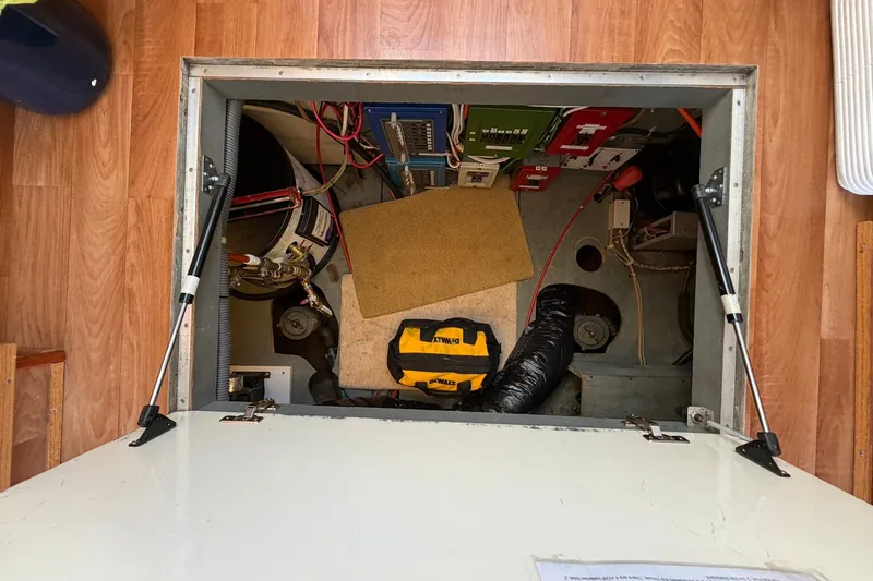 Slide: The Image of Engine compartment of a 1973 Chris-Craft 31 Sedan Cruiser with visible tools and equipment. - 64
