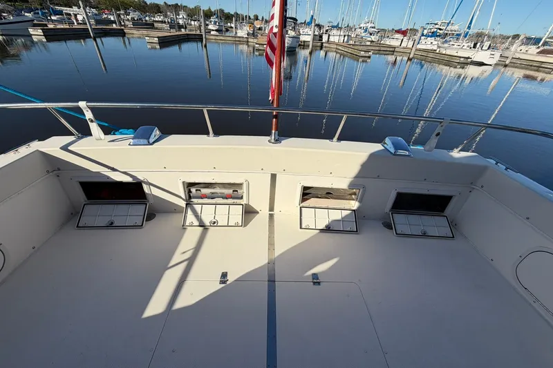Slide: The Image of 1973 Chris-Craft 31 Sedan Cruiser deck with storage compartments, docked at marina. - 13