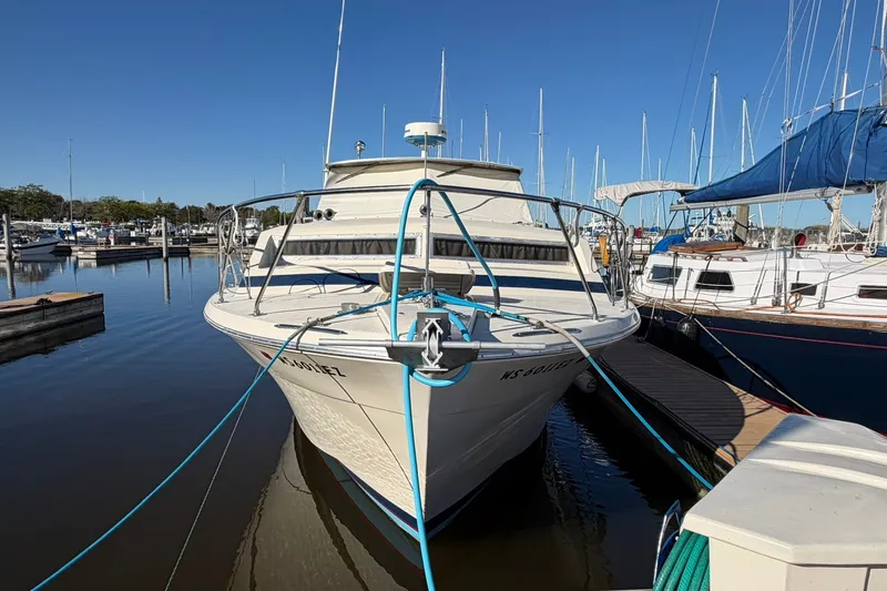 Slide: The Image of 1973 Chris-Craft 31 Sedan Cruiser docked at a marina on a sunny day. - 8