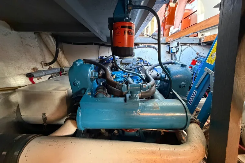 Slide: The Image of Engine room of a 1973 Chris-Craft 31 Sedan Cruiser with visible blue engine components. - 24